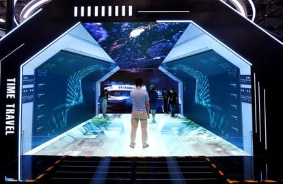 Visitors experience the metaverse at a Beijing trade show.